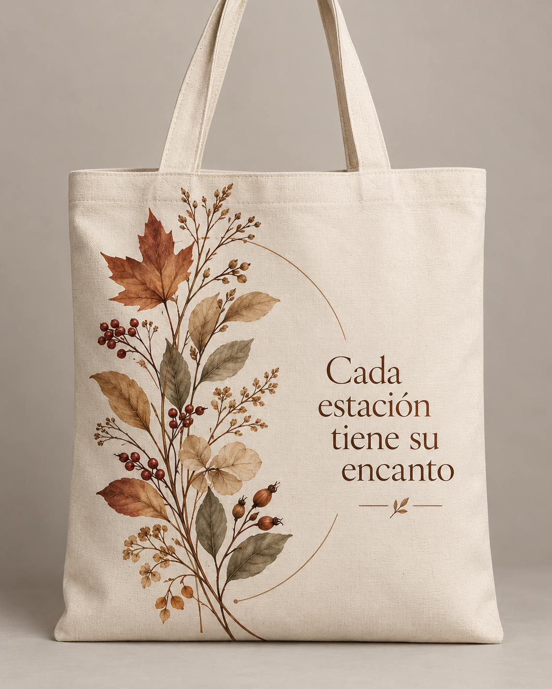 Bolsa tote crema con hojas otoñales, ramas delicadas y frase Cada estación tiene su encanto.