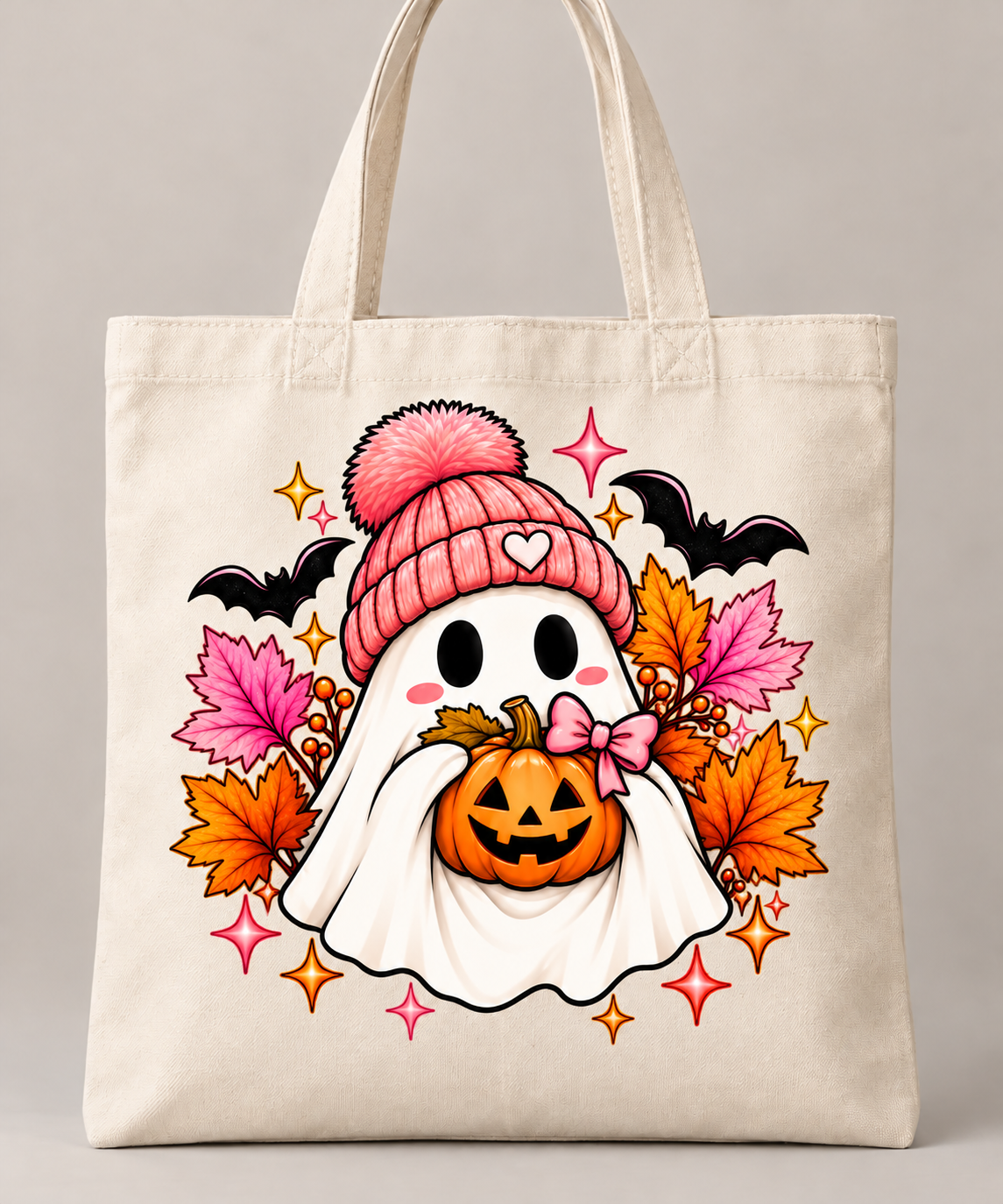 Bolsa tote crema con fantasmita de Halloween, gorro rosa, calabaza y hojas otoñales.